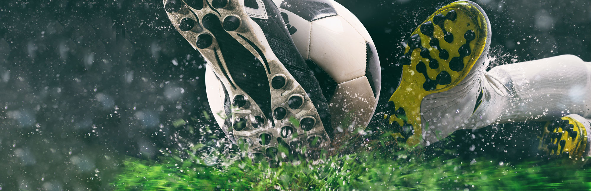 Soccer player sliding on synthetic turf in the rain, showcasing durability and high-performance artificial grass.