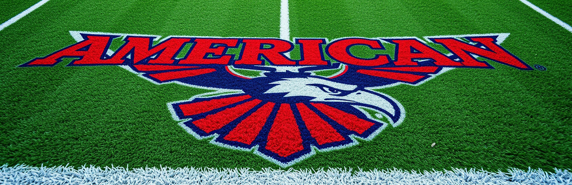 Custom artificial turf logo featuring a bold eagle design in red, white, and blue with the word AMERICAN prominently displayed above. The advanced tufting technology ensures sharp details and vibrant colors, making it ideal for sports fields and patriotic branding.