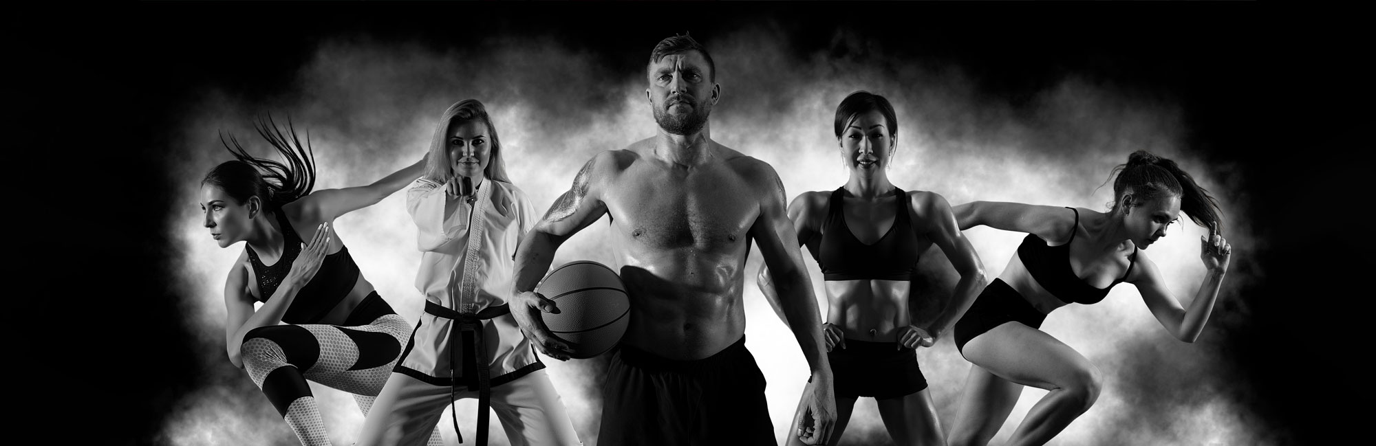 Black and white image of diverse athletes engaged in various sports, highlighting the versatility of multi-sport synthetic turf surfaces